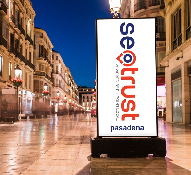 A billboard advertising trust in a city at night, attracting attention from passersby searching for a nearby website designer or SEO company.